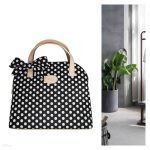 Schwarz-weiße gepunktete Handtasche mit eine Schleife